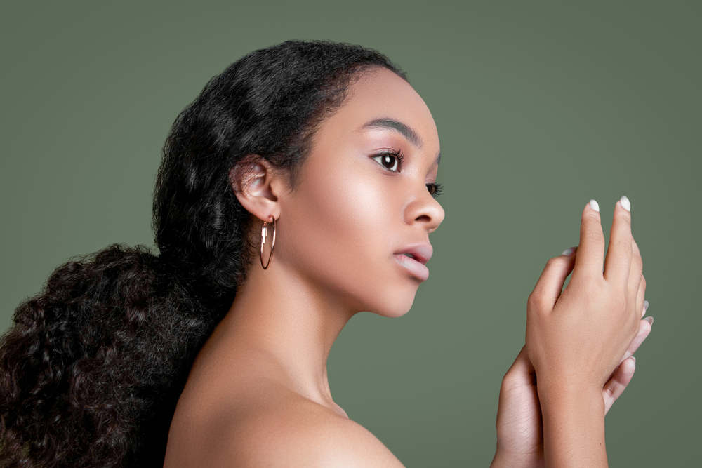 Voor een stuk over mixed race leuke kapsels voor krullend haar, draagt een vrouw een Sophisticated Low Pony