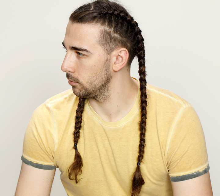 Man In a Yellow T-Shirt Wearing Two Long Braids