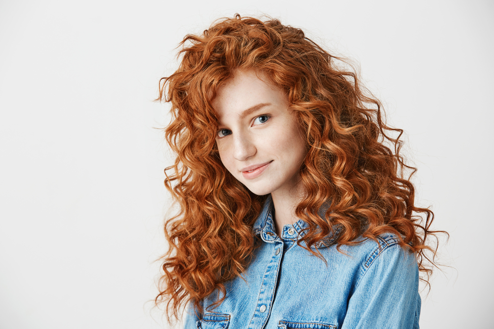 Afbeelding van een vrouw met Vurig licht Koper haar, een van de beste haarkleuren voor krullend haar