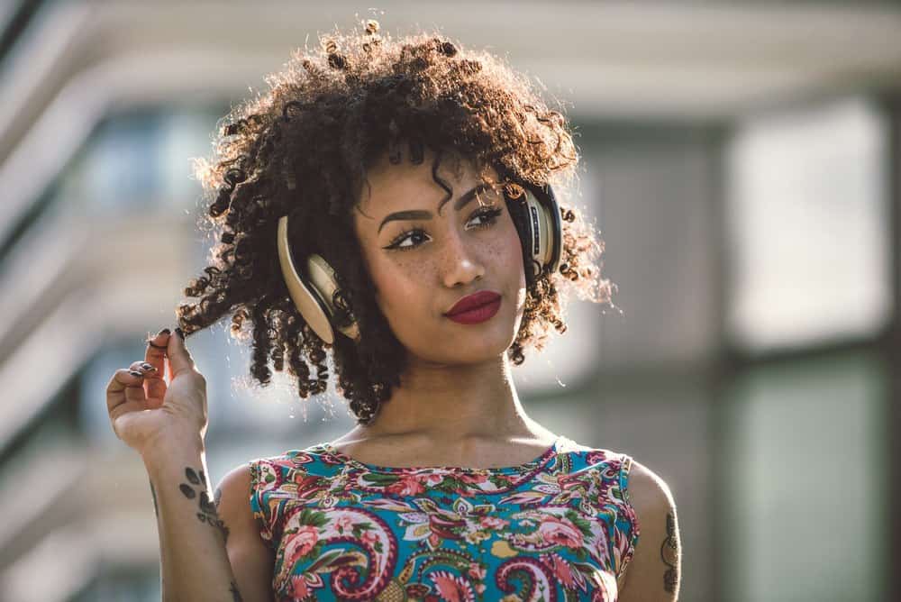 Portret van een Latijns-Amerikaanse jonge vrouw die een jurk met bloemmotief draagt.