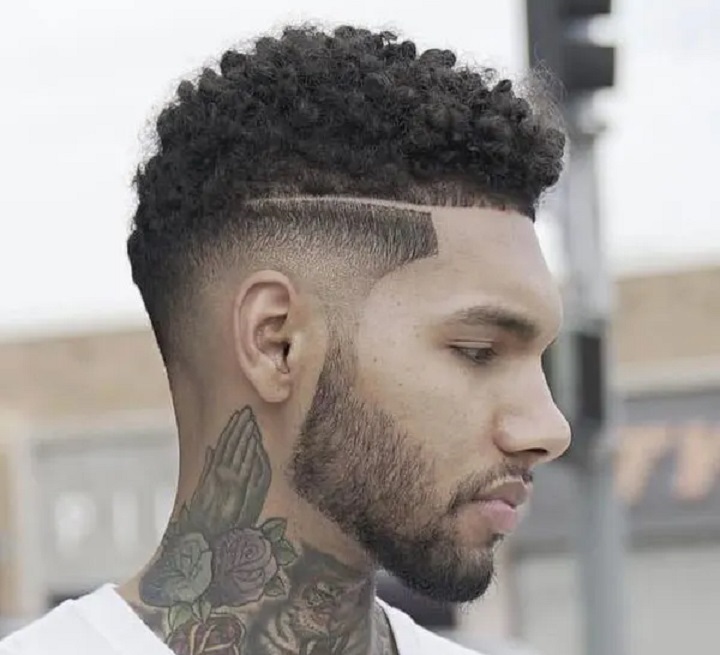 Tattooed Man With a Coils Thot Boy Haircut